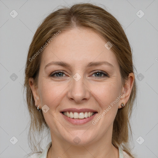 Joyful white adult female with medium  brown hair and grey eyes