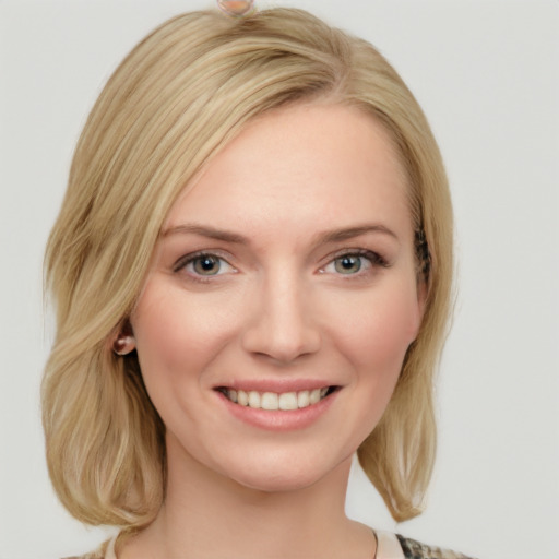 Joyful white young-adult female with medium  brown hair and blue eyes