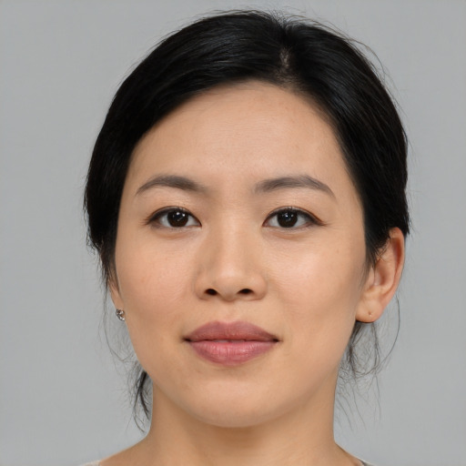 Joyful asian young-adult female with medium  black hair and brown eyes