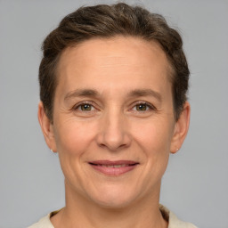 Joyful white adult female with short  brown hair and brown eyes