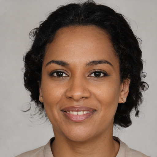 Joyful black young-adult female with medium  black hair and brown eyes