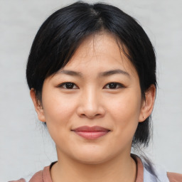 Joyful asian young-adult female with medium  black hair and brown eyes