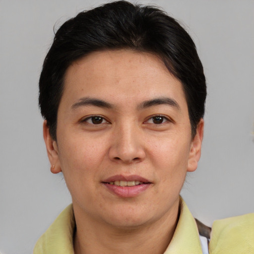 Joyful asian adult female with short  brown hair and brown eyes