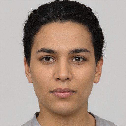 Neutral latino young-adult male with short  black hair and brown eyes