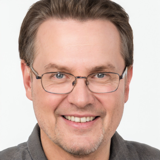 Joyful white adult male with short  brown hair and grey eyes