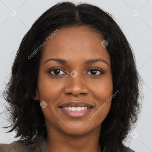 Joyful black young-adult female with long  brown hair and brown eyes