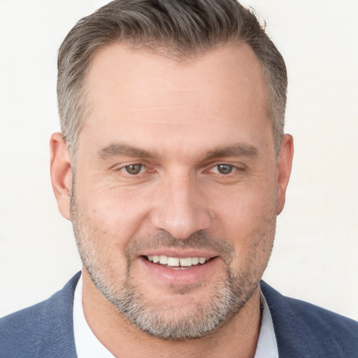 Joyful white adult male with short  brown hair and brown eyes