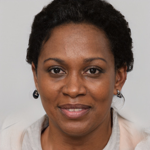 Joyful black adult female with short  black hair and brown eyes