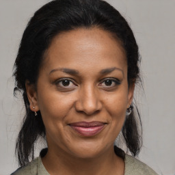 Joyful black adult female with medium  brown hair and brown eyes