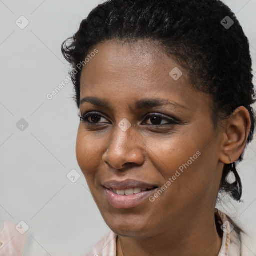 Joyful black young-adult female with short  brown hair and brown eyes