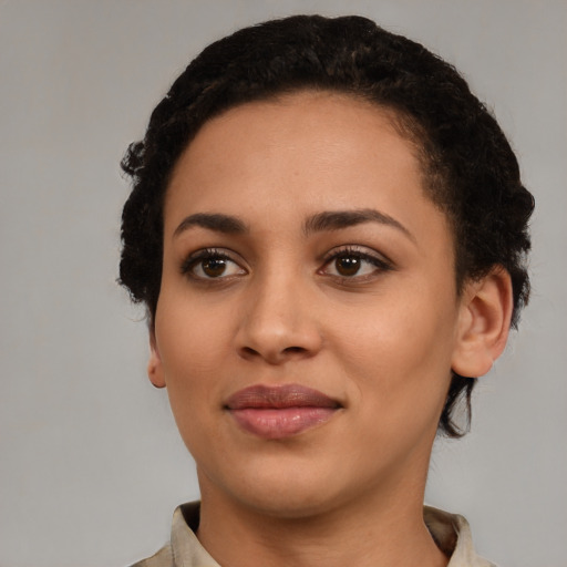Joyful latino young-adult female with short  black hair and brown eyes
