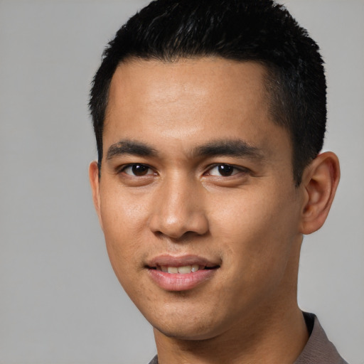 Joyful latino young-adult male with short  black hair and brown eyes