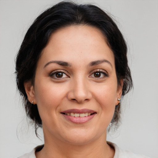 Joyful white adult female with medium  brown hair and brown eyes