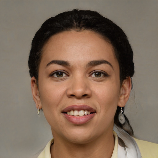 Joyful latino young-adult female with short  black hair and brown eyes