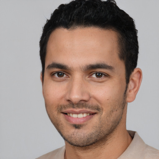 Joyful white young-adult male with short  black hair and brown eyes