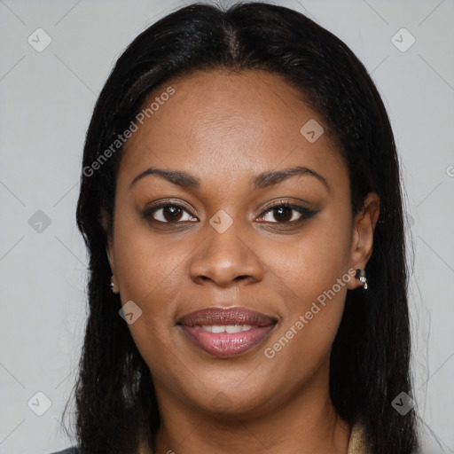 Joyful black young-adult female with long  black hair and brown eyes