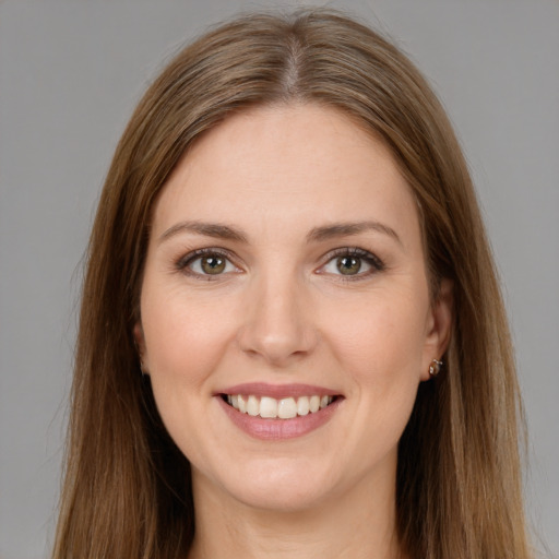 Joyful white young-adult female with long  brown hair and brown eyes