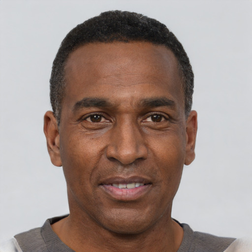 Joyful black adult male with short  black hair and brown eyes