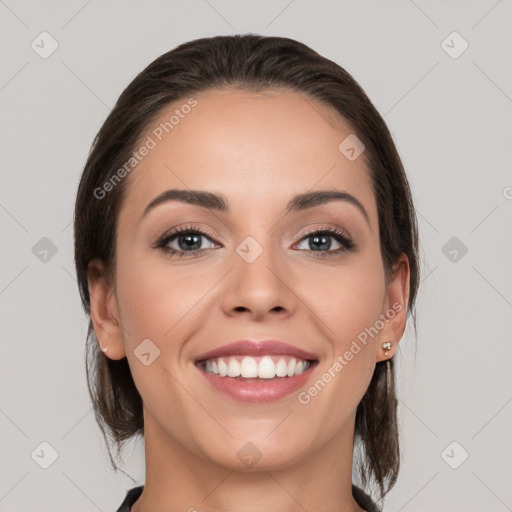 Joyful white young-adult female with medium  brown hair and grey eyes