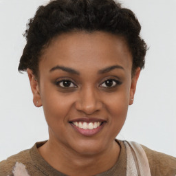 Joyful black young-adult female with short  brown hair and brown eyes