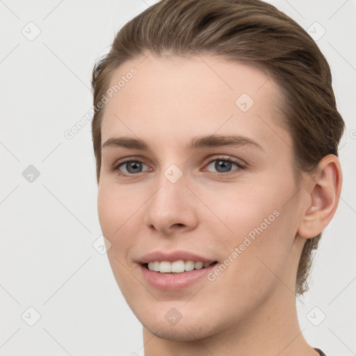 Joyful white young-adult female with short  brown hair and grey eyes