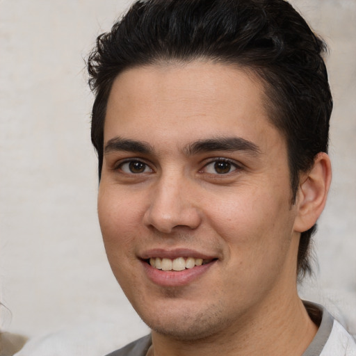 Joyful white young-adult male with medium  brown hair and brown eyes