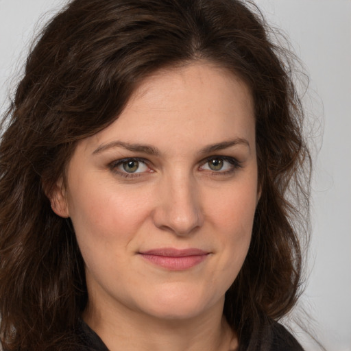 Joyful white young-adult female with medium  brown hair and green eyes