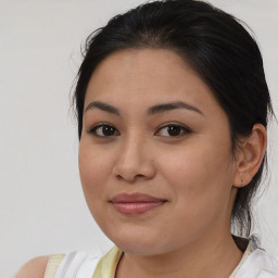 Joyful latino young-adult female with medium  brown hair and brown eyes