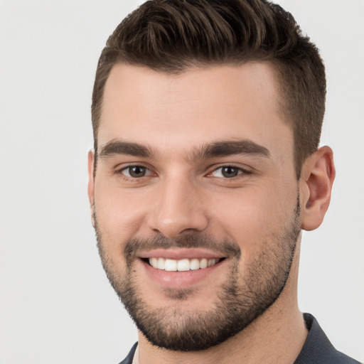 Joyful white young-adult male with short  brown hair and brown eyes