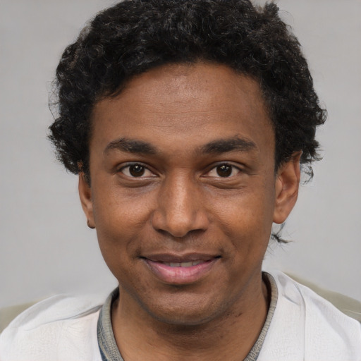 Joyful latino young-adult male with short  brown hair and brown eyes