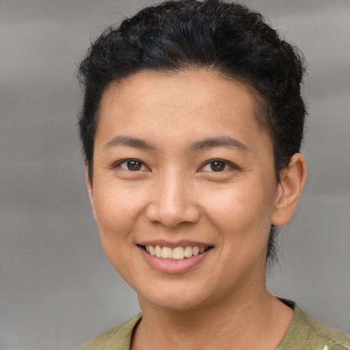 Joyful latino young-adult female with short  brown hair and brown eyes