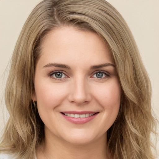 Joyful white young-adult female with long  brown hair and green eyes