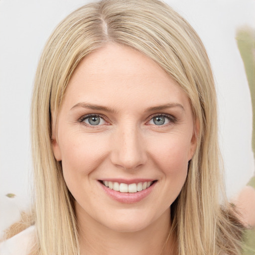 Joyful white young-adult female with long  brown hair and green eyes