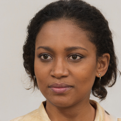 Joyful black young-adult female with medium  brown hair and brown eyes