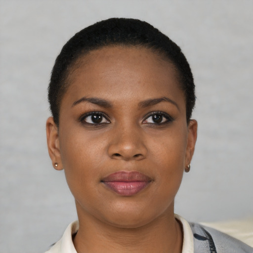 Joyful black young-adult female with short  brown hair and brown eyes