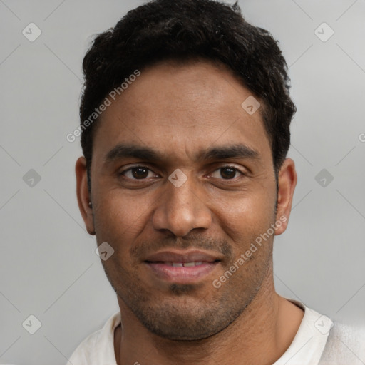 Joyful white young-adult male with short  black hair and brown eyes