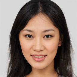 Joyful asian young-adult female with long  brown hair and brown eyes