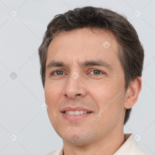 Joyful white adult male with short  brown hair and brown eyes