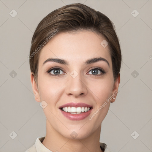 Joyful white young-adult female with short  brown hair and grey eyes