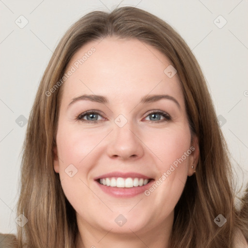 Joyful white young-adult female with long  brown hair and grey eyes