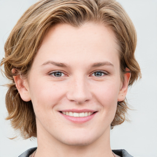 Joyful white young-adult female with medium  brown hair and blue eyes