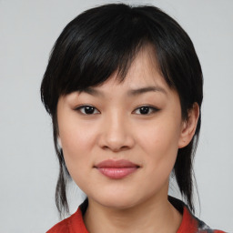 Joyful asian young-adult female with medium  black hair and brown eyes