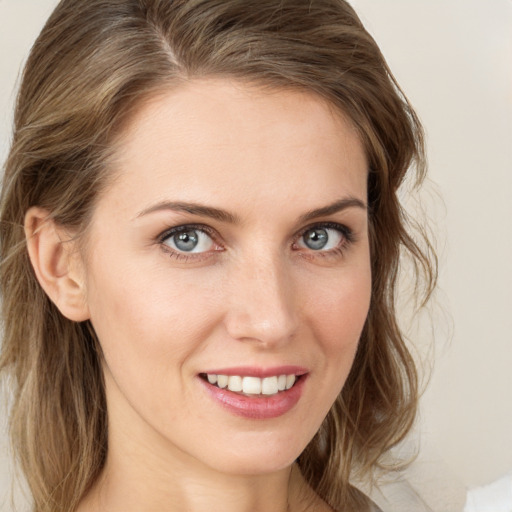 Joyful white young-adult female with medium  brown hair and grey eyes