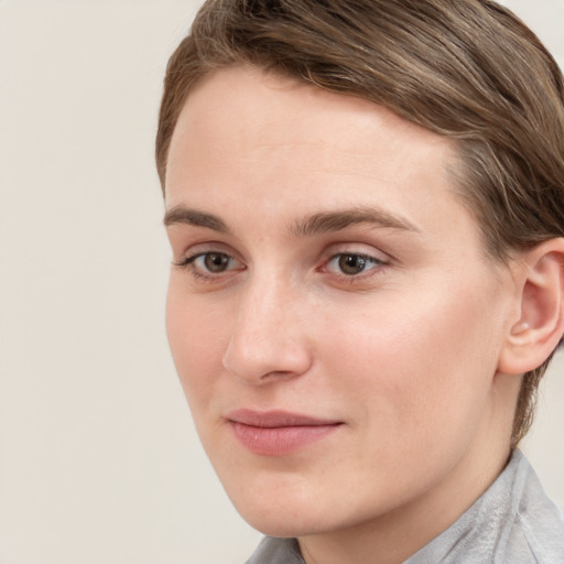 Joyful white young-adult female with short  brown hair and grey eyes