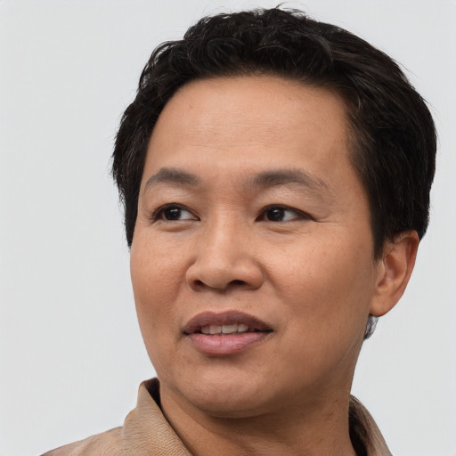 Joyful asian adult male with short  black hair and brown eyes