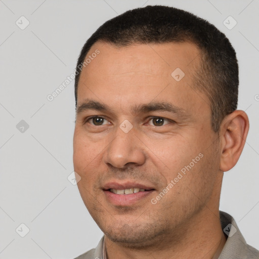 Joyful white adult male with short  black hair and brown eyes