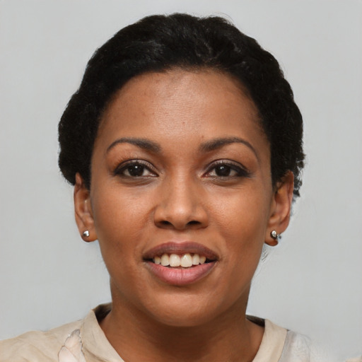 Joyful latino young-adult female with short  black hair and brown eyes
