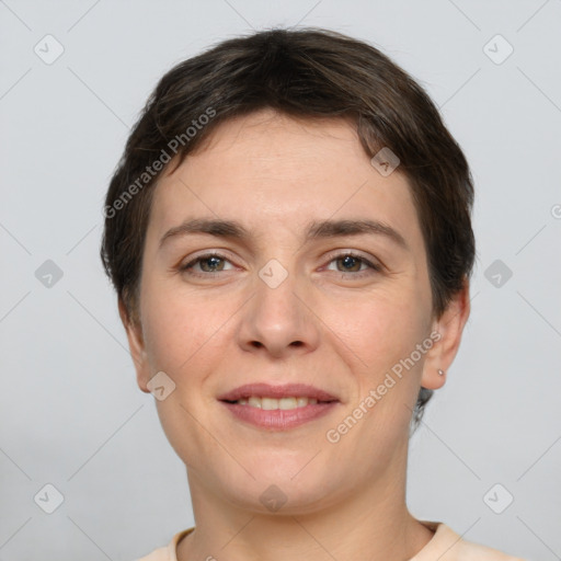 Joyful white young-adult female with short  brown hair and grey eyes