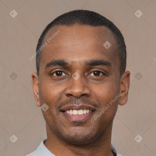 Joyful black young-adult male with short  black hair and brown eyes