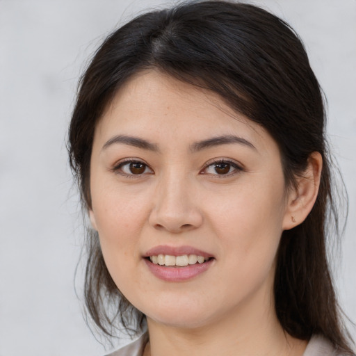 Joyful white young-adult female with medium  brown hair and brown eyes